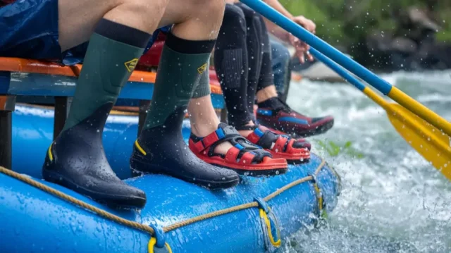 Close-up of expert-recommended rafting footwear, including water shoes and neoprene boots, in action on a raft.