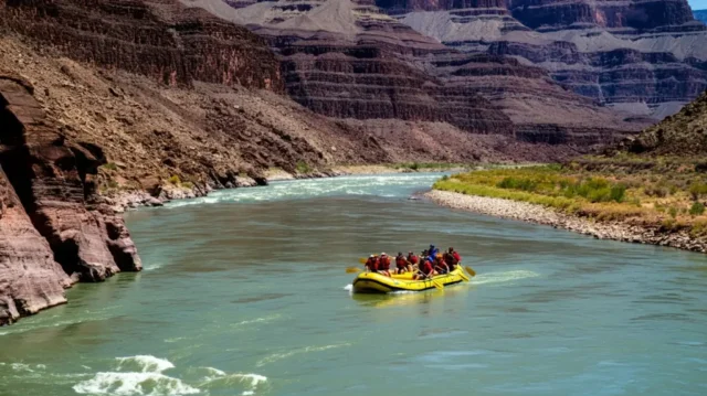 An aerial view of rafters navigating rapids on the Colorado River in the Grand Canyon.