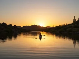 Kayaker paddling on the Salt River at sunrise, with desert cliffs in the background, highlighting kayaking rental opportunities.
