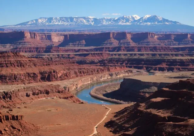Things to do in Moab, Utah beyond Arches: Panoramic view of the diverse landscape including the Colorado River, canyons, and La Sal Mountains.