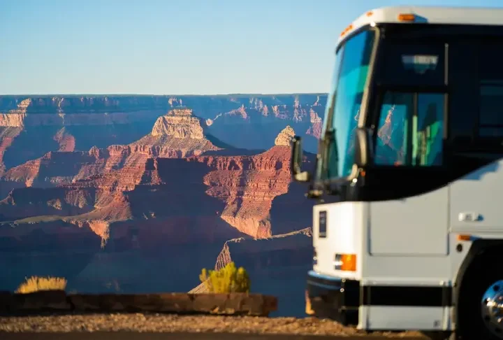 Grand Canyon travel packages worth the cost? View of the canyon with a tour bus subtly present.