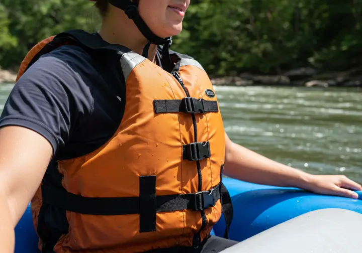 Prioritizing your safety first: close-up of a rafter wearing essential PFD and helmet on the Ocoee River.