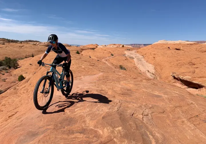 Ride world-class trails in Moab: Mountain biker navigating the unique slickrock terrain.