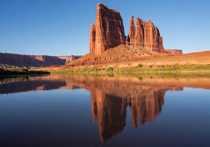 Essential Moab rafting insights: Iconic view of the Fisher Towers landmark during a Colorado River Daily Float trip.