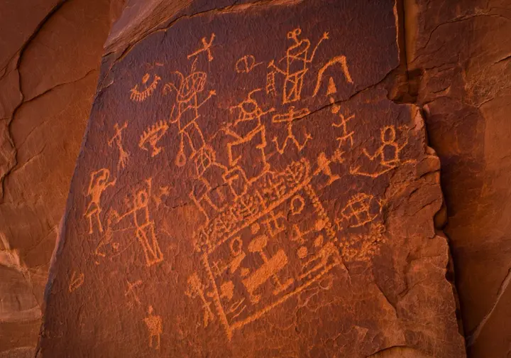 Discover unique Moab history: Close-up of ancient petroglyphs on a sandstone cliff near Moab.