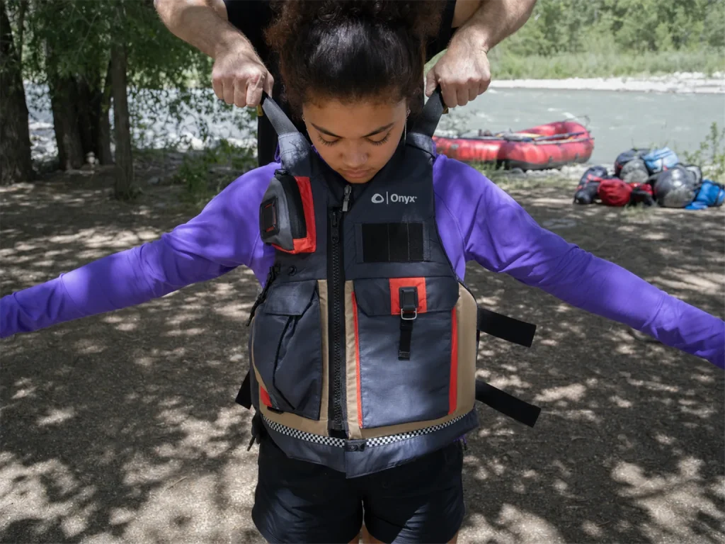 Running the ride-up test on an Onyx MoveVent Dynamic PFD by pulling up hard on the shoulder straps