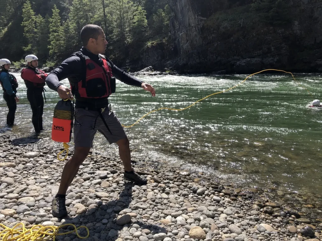 Student throwing a rescue rope during a swiftwater course, the training behind a river rescue kit