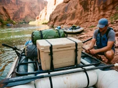 Best Cooler for Rafting That Survives a Flip Canyon Coolers Prospector rigged on a raft frame at a desert river put-in for a rafting trip