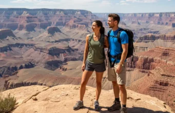 Training for Grand Canyon Rafting: A Role-Based Guide An athletic man and woman in their late 20s, wearing hiking gear and backpacks, stand on a rocky ledge overlooking a massive desert canyon, training for a rafting trip.