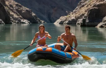 Laminar vs Turbulent Flow: A Rafter’s Guide to River Reading A fit couple in their late 20s rafting on a sunny river, moving from a calm, glassy section of water towards turbulent whitewater rapids ahead.