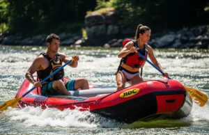 Master Raft Ferrying: Pro Techniques & Angle Matrix An attractive couple in their late 20s works together to ferry a whitewater raft across a sunny, powerful river.