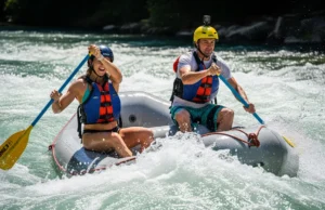 Mastering Rafting Safety: A Class I-V River Guide A fit couple in their late 20s, wearing PFDs and helmets over swimwear, confidently paddling a whitewater raft through a sunny rapid.