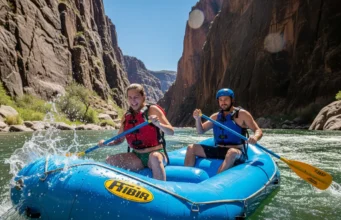 Middle Fork Salmon Rafting: A Data-Backed Planning Guide A full-body shot of an attractive young couple in swimwear and PFDs rafting down the Middle Fork of the Salmon River through a sunlit granite canyon.