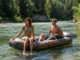 Read Any River: The River Continuum Concept Explained A man and woman in their late 20s on a raft, looking downriver to illustrate the concept of reading the water.