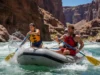 The River Communication Code: Rafting Slang Explained A male river guide yells a command to a female rafter in a one-piece swimsuit as they paddle through a rapid in a full-body, wide-angle shot