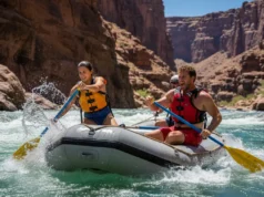 The River Communication Code: Rafting Slang Explained A male river guide yells a command to a female rafter in a one-piece swimsuit as they paddle through a rapid in a full-body, wide-angle shot