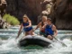 River Hydraulics: How Flow & Features Affect Your Line A full-body shot of a young man and woman in a raft, actively paddling through whitewater on a sunny day.