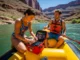 River Trip First Aid: A Field-Tested Planning Guide A man and a woman in their late 20s on a raft, preparing their comprehensive first aid kit for a river expedition.