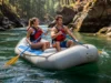 Mastering the Rogue: A Tactical River Rafting Guide A fit young couple in a raft navigate a sunny, tree-lined canyon on the Rogue River.