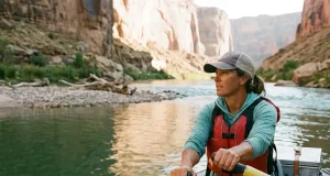 Wood vs Carbon Rafting Oars What Most Rafters Get Wrong Rafter rowing an oar rig with Sawyer composite oars on a calm desert river reach