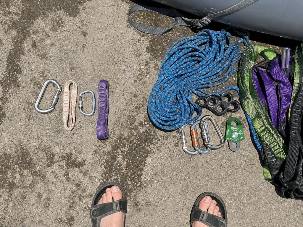 A minimal raft pin kit and a full outfitter kit laid side by side on a boat ramp for comparison