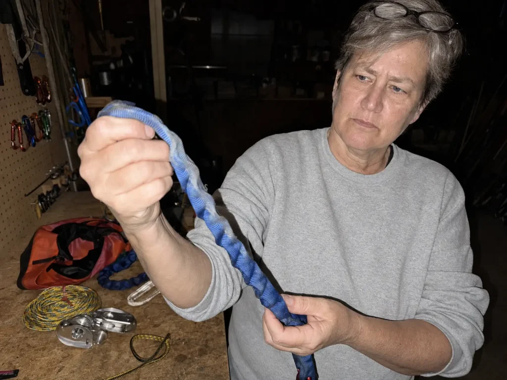 Pre-season inspection of raft pin kit webbing checking for UV fading and frayed edges