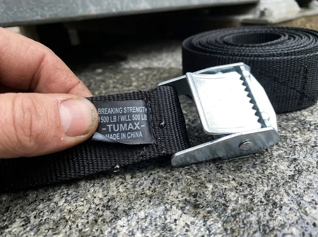 Reading the breaking strength printed on a cam strap label to work out its safe working load