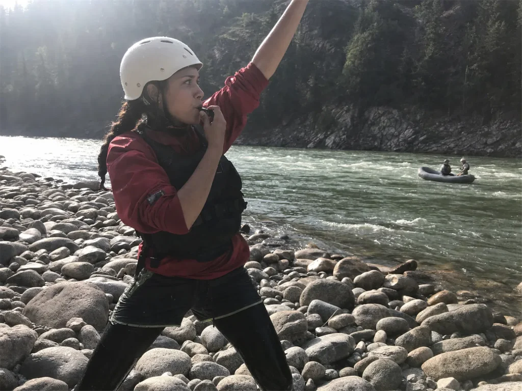 Rafter signaling three whistle blasts from shore with a Fox 40 Classic pealess whistle