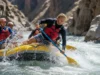 How to Paddle Brace in a Raft: The Definitive Safety Guide A male rafter in a PFD executes a perfect low paddle brace to stabilize his raft in a challenging whitewater rapid.
