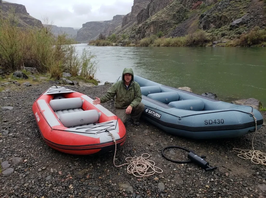 Saturn 9.6 ft and 13 ft beginner whitewater rafts side by side showing the size difference on a river bank