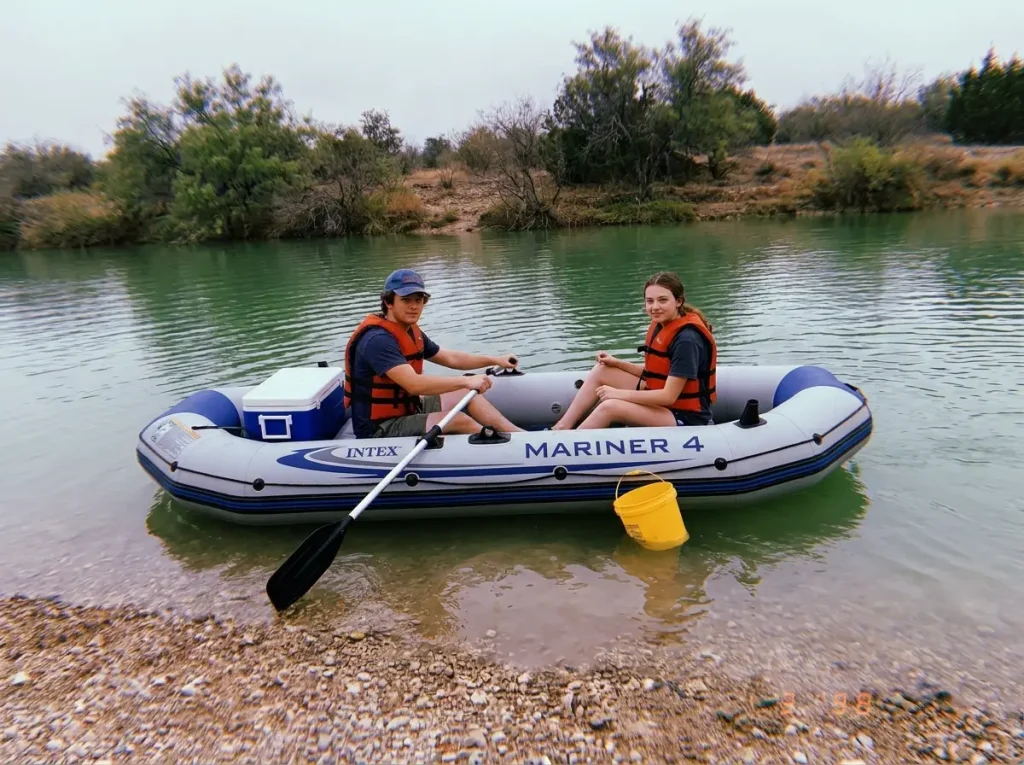 Bucket boat with a sealed floor on calm low water, two paddlers and a bail bucket aboard