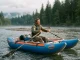 Cataraft Buying Guide The Frame Cost No One Quotes Rower running an AIRE Wave Destroyer cataraft through a riffle on a cool morning river