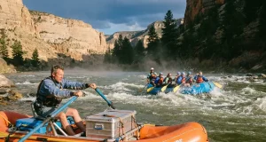 Paddle Raft vs Oar Raft vs Hybrid Which Fits Your River Oar raft and paddle raft running the same rapid, showing the paddle raft vs oar raft choice