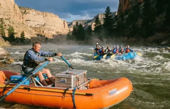 Paddle Raft vs Oar Raft vs Hybrid Which Fits Your River Oar raft and paddle raft running the same rapid, showing the paddle raft vs oar raft choice