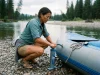 12V vs Hand Raft Pumps Which Hits Pressure River runner topping off a raft tube with a K-Pump K-200 hand pump at a put-in