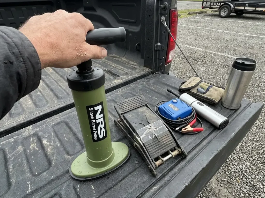 Different raft pump types laid out on a tailgate including an NRS barrel pump