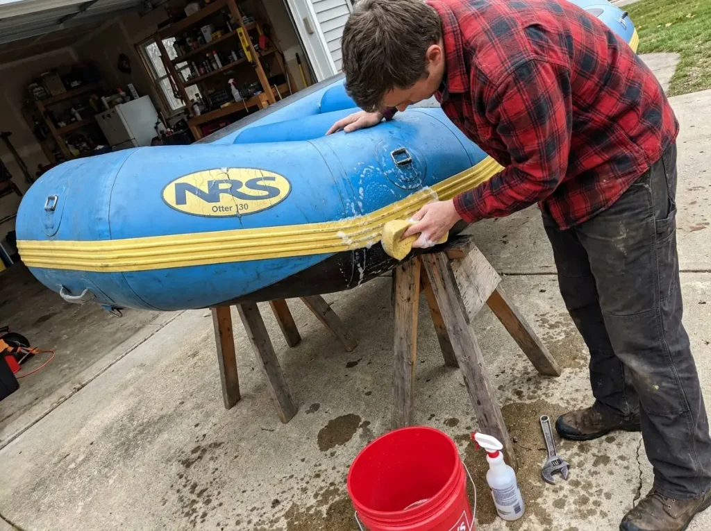 Soapy-water seam leak test on a used budget whitewater raft chamber