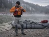 Best Drysuits for Rafting or Rent One First Rafter in a drysuit at a cold-water put-in checking gear before launch on a spring morning
