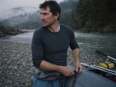 Cold-Water Rafting Base Layers Guides Swear By Rafter in a merino base layer rigging at a cold river put-in before a cold-water run