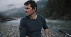 Cold-Water Rafting Base Layers Guides Swear By Rafter in a merino base layer rigging at a cold river put-in before a cold-water run