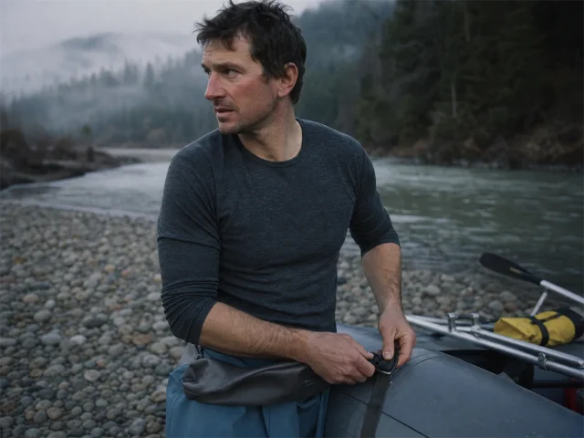 0-cold-water-rafting-base-layer-hero Rafter in a merino base layer rigging at a cold river put-in before a cold-water run