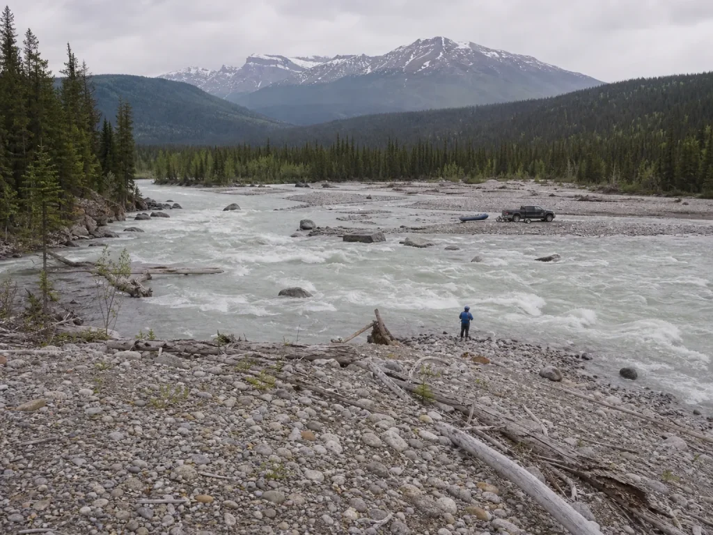 Snowmelt river running through a valley showing seasonal flow and color