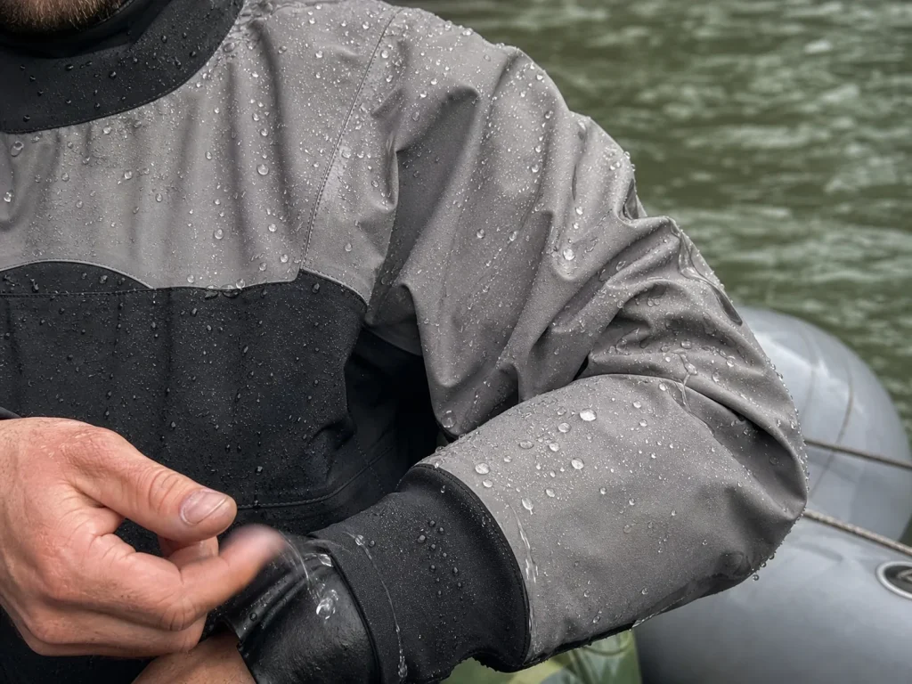 Water beading on the Gore-Tex shell sleeve of a rafting drysuit showing waterproof fabric