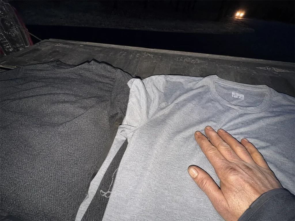 Budget synthetic base layer and a merino top on a truck tailgate weighing cost against warmth for rafting