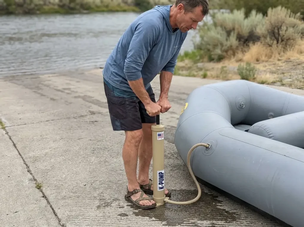 Boater using a K-Pump K-200 barrel pump to top off a raft tube to full inflation pressure