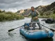 Raft Fishing Frame Setup Mistakes That Can Trap Your Feet Angler standing to cast from a fully rigged raft fishing frame setup on a calm river