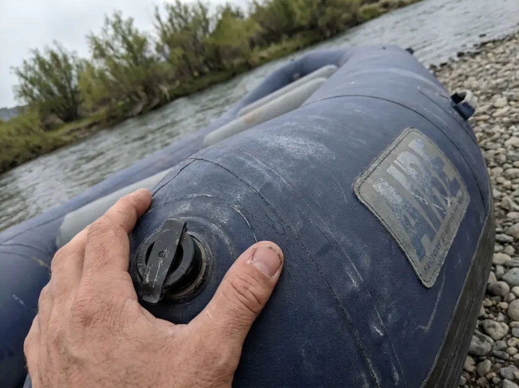 Close inspection of an aging AIRE raft tube showing fading and wear that signal raft lifespan
