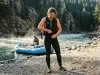 What to Wear Rafting When the Water’s Colder Than the Air Rafter at the put-in dressed for cold water in a wetsuit before a shoulder-season whitewater run