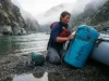 Best Dry Bags for Whitewater That Survive a Flip Yellow NRS dry bag rigged to a raft frame before a whitewater run at dawn