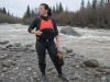 Best Rescue PFDs Type V and Who Should Skip Them Safety boater in an Astral GreenJacket rescue PFD, a Type V rescue vest, on a cold spring river